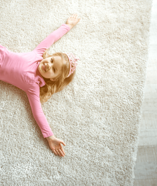Cute girl laying on rug |  Gainesville CarpetsPlus COLORTILE